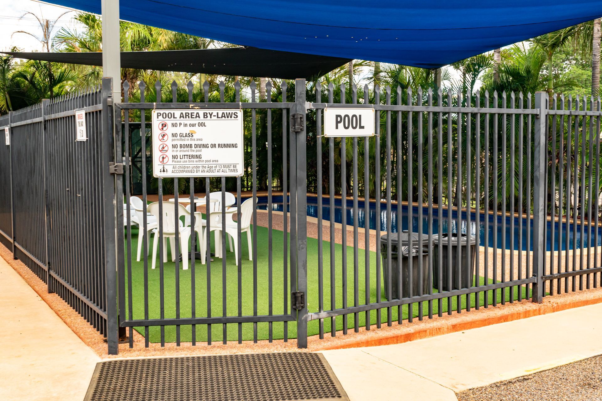 Night Shot of A Pool with Purple Lights Surrounded by A Fence and Chairs — Leichhardt Accommodation in Mornington, QLD