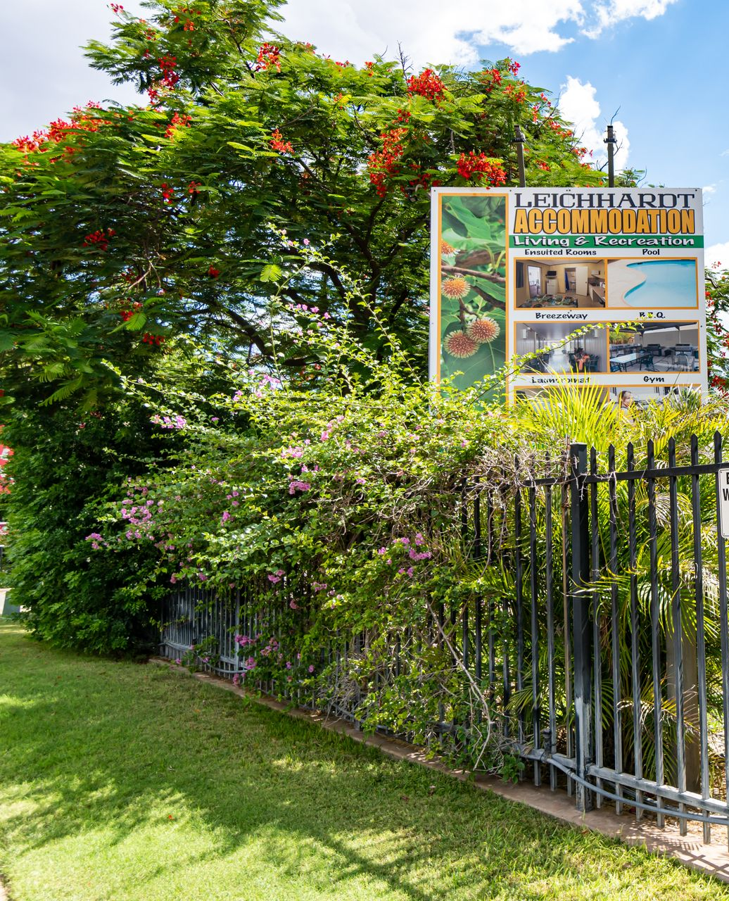 A White Van Is Parked In Front Of A Building — Leichhardt Accommodation in Mornington, QLD