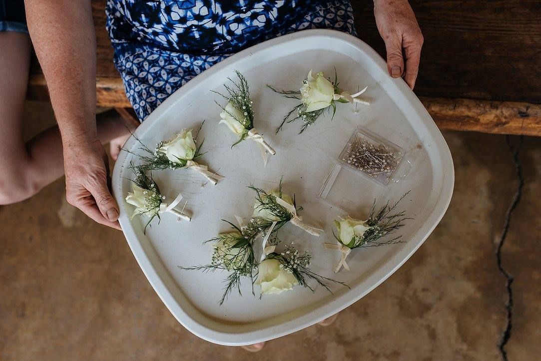A woman is holding a tray of flowers in her hands.