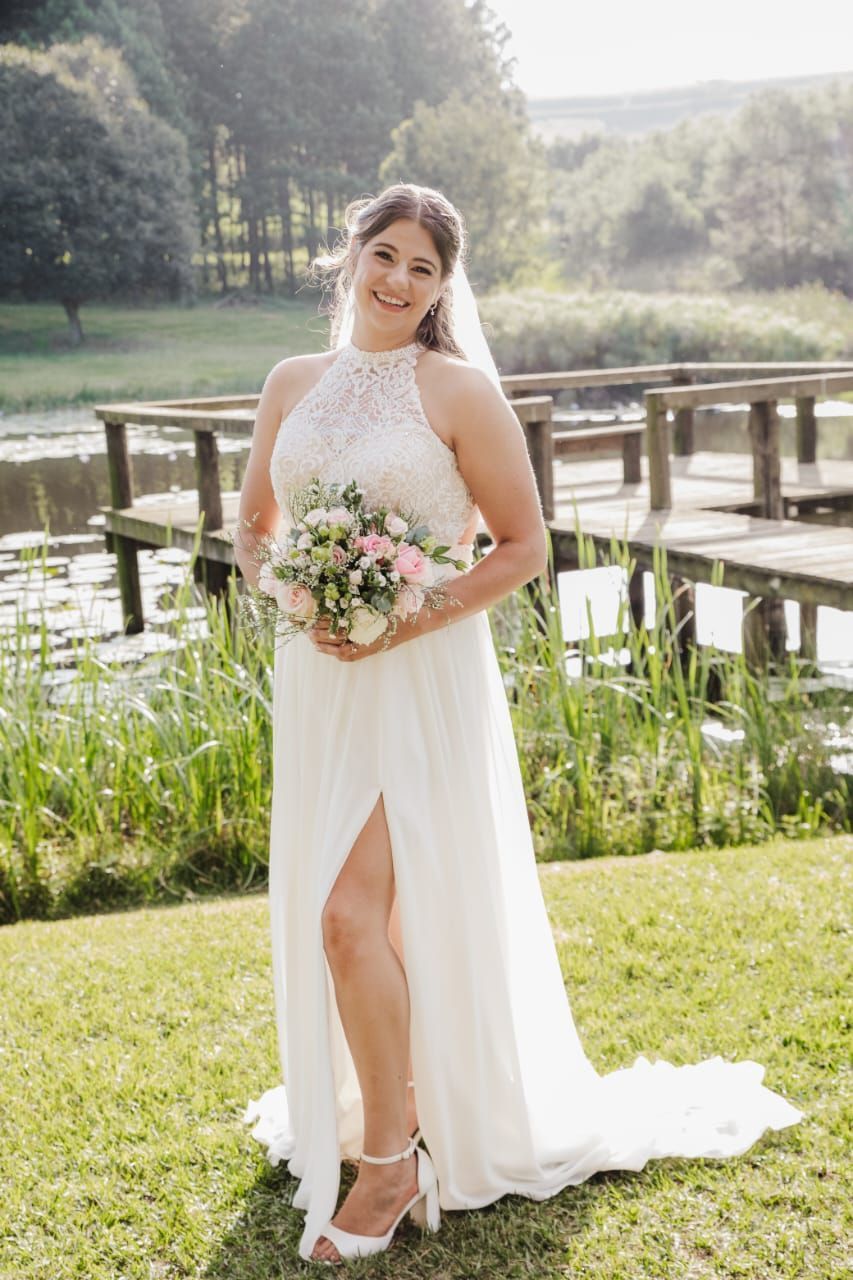 The bride is wearing a white dress and holding a bouquet of flowers.