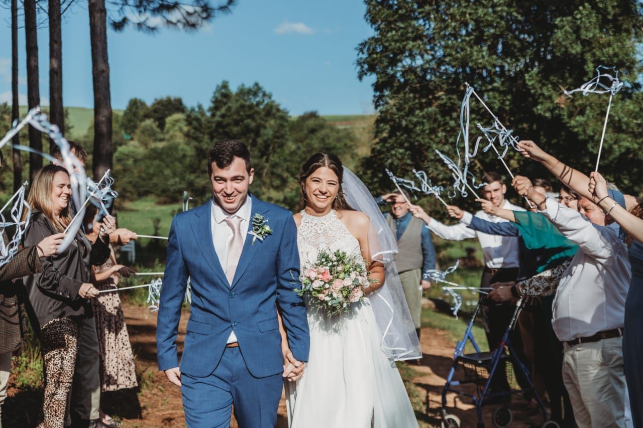 A bride and groom are walking down the aisle at their wedding.