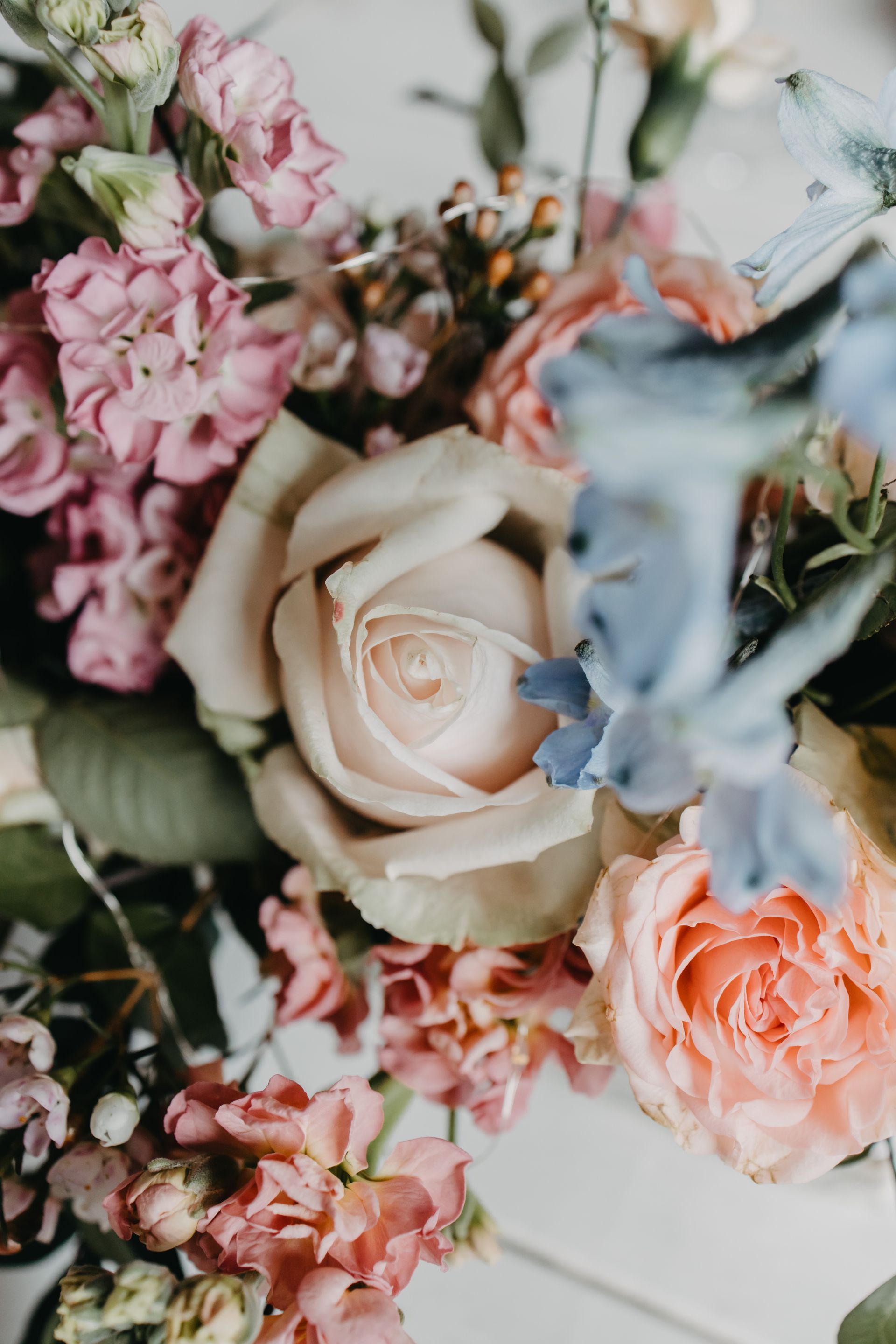 A bridesmaid is holding a basket of flowers in her hand.