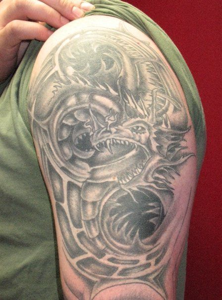A man has a tattoo of a dragon on his arm