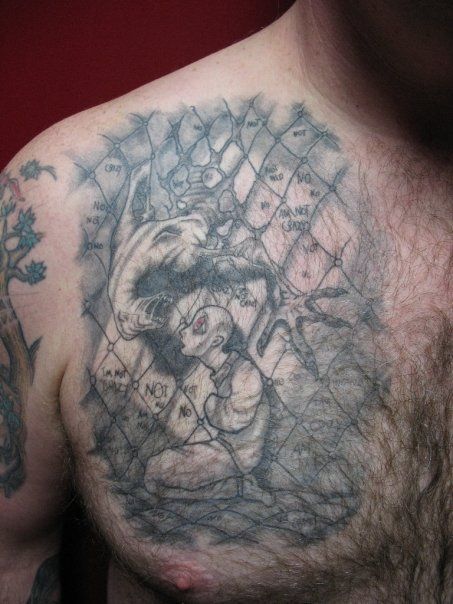 A man with a tattoo on his chest and shoulder.