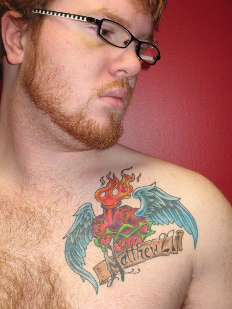 A man has a tattoo on his chest that says