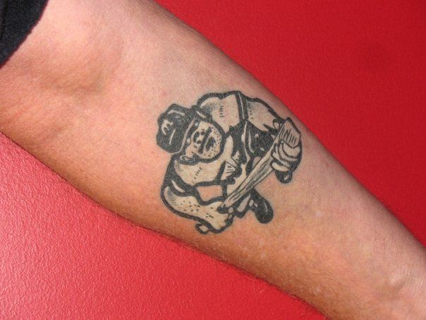 A person has a tattoo of a baseball player on their arm