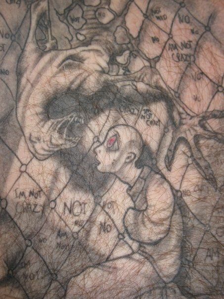 A close up of a tattoo on a person 's back.