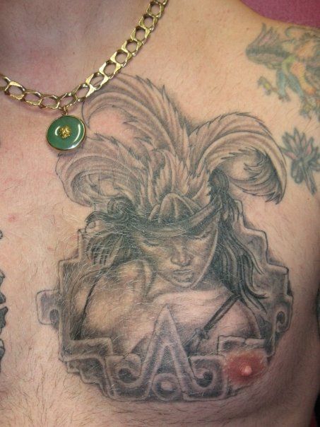A man has a tattoo of a woman on his chest