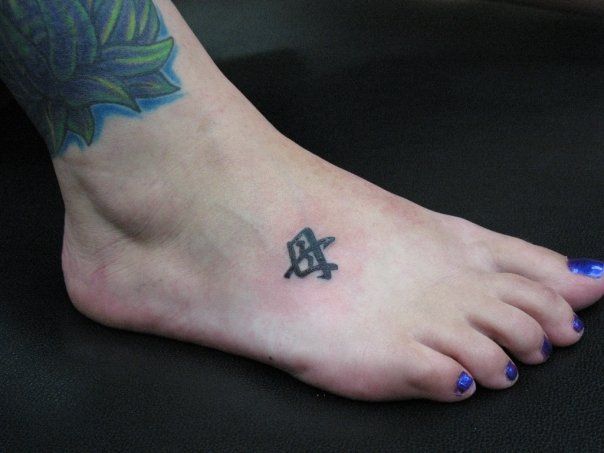 A woman has a small tattoo on her foot