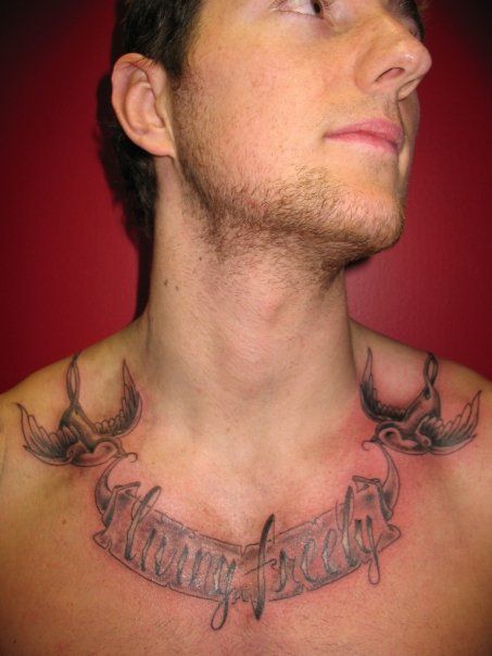 A man has a tattoo on his chest that says heavy freely.