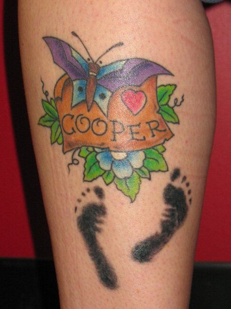 A tattoo of a butterfly with the name cooper on it