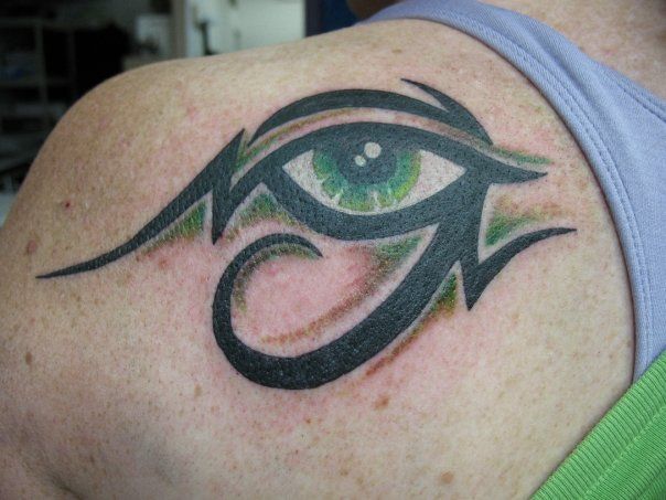 A woman has a tattoo of an eye on her shoulder