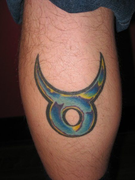 A person has a taurus tattoo on their leg.