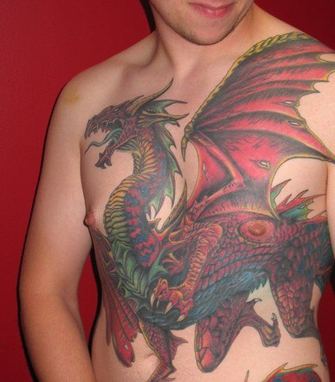 A shirtless man has a dragon tattoo on his chest