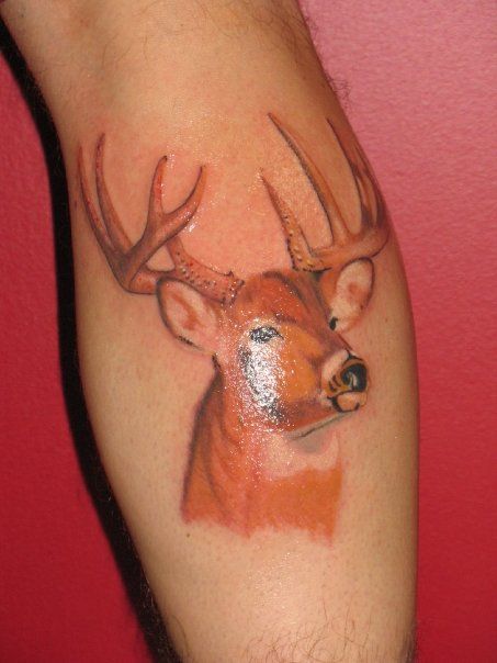 A person has a tattoo of a deer on their leg