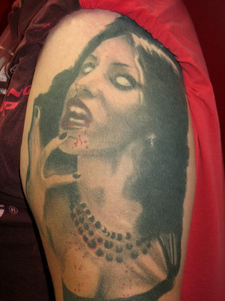 A person has a tattoo of a woman on their arm