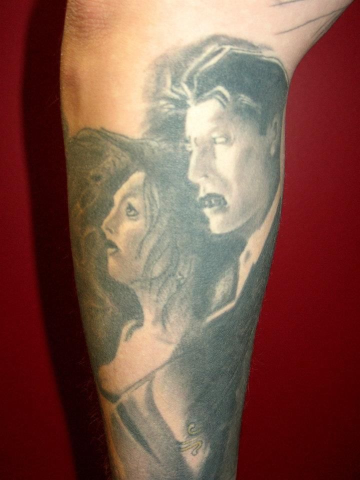A man has a tattoo of a man and a woman on his leg