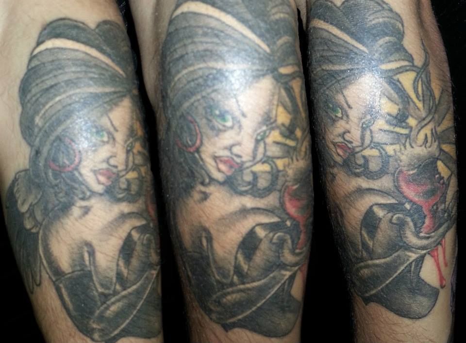 A man has a tattoo of a woman on his arm.