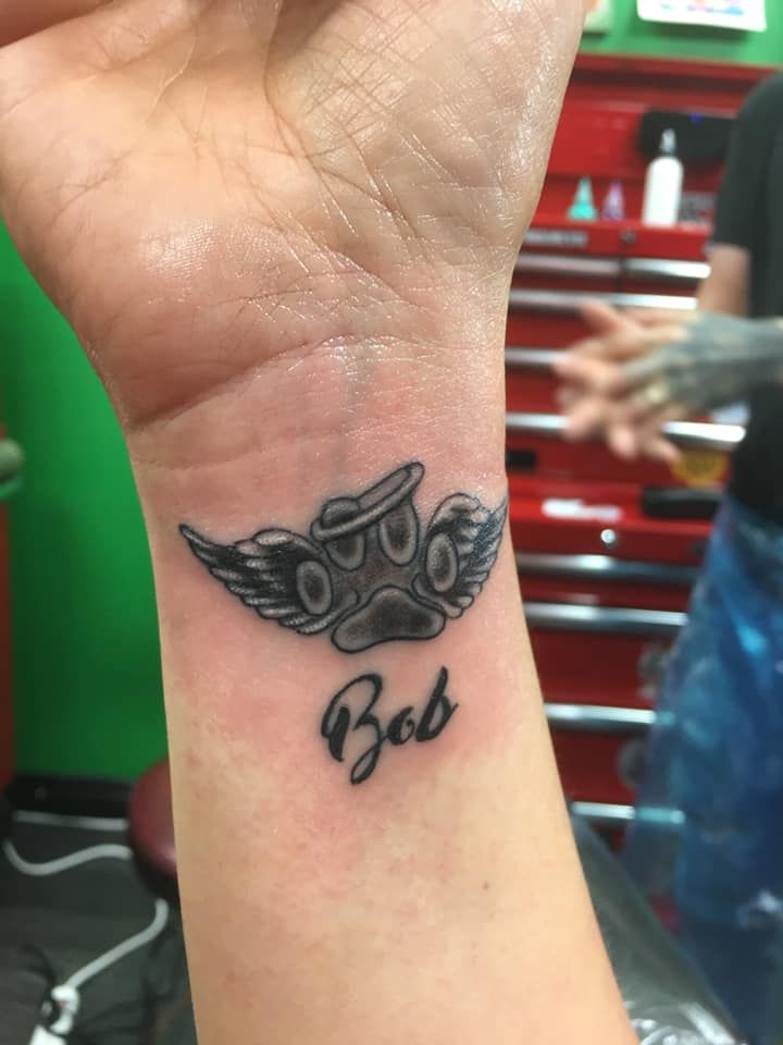A person has a tattoo on their wrist that says bob