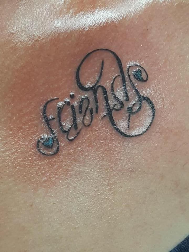 A close up of a tattoo that says friends
