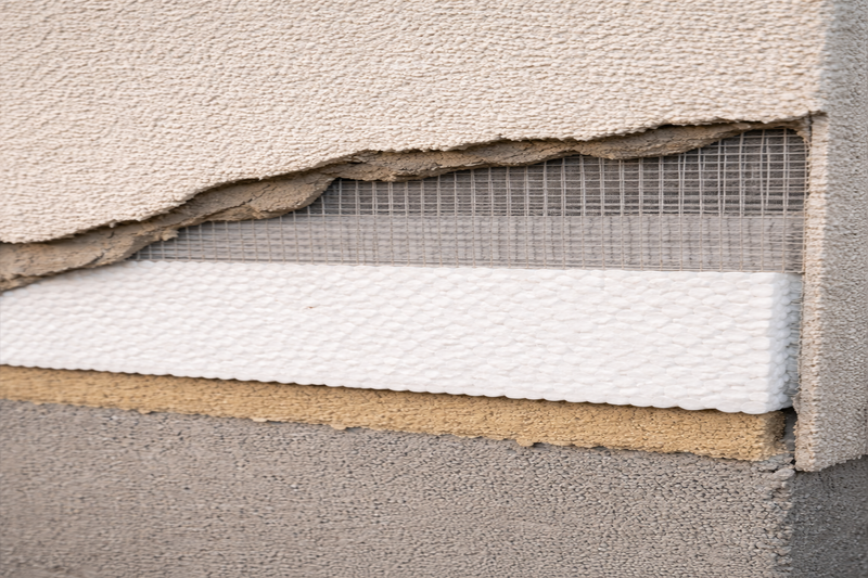 EIFS stucco system showing moisture damage beneath the surface
