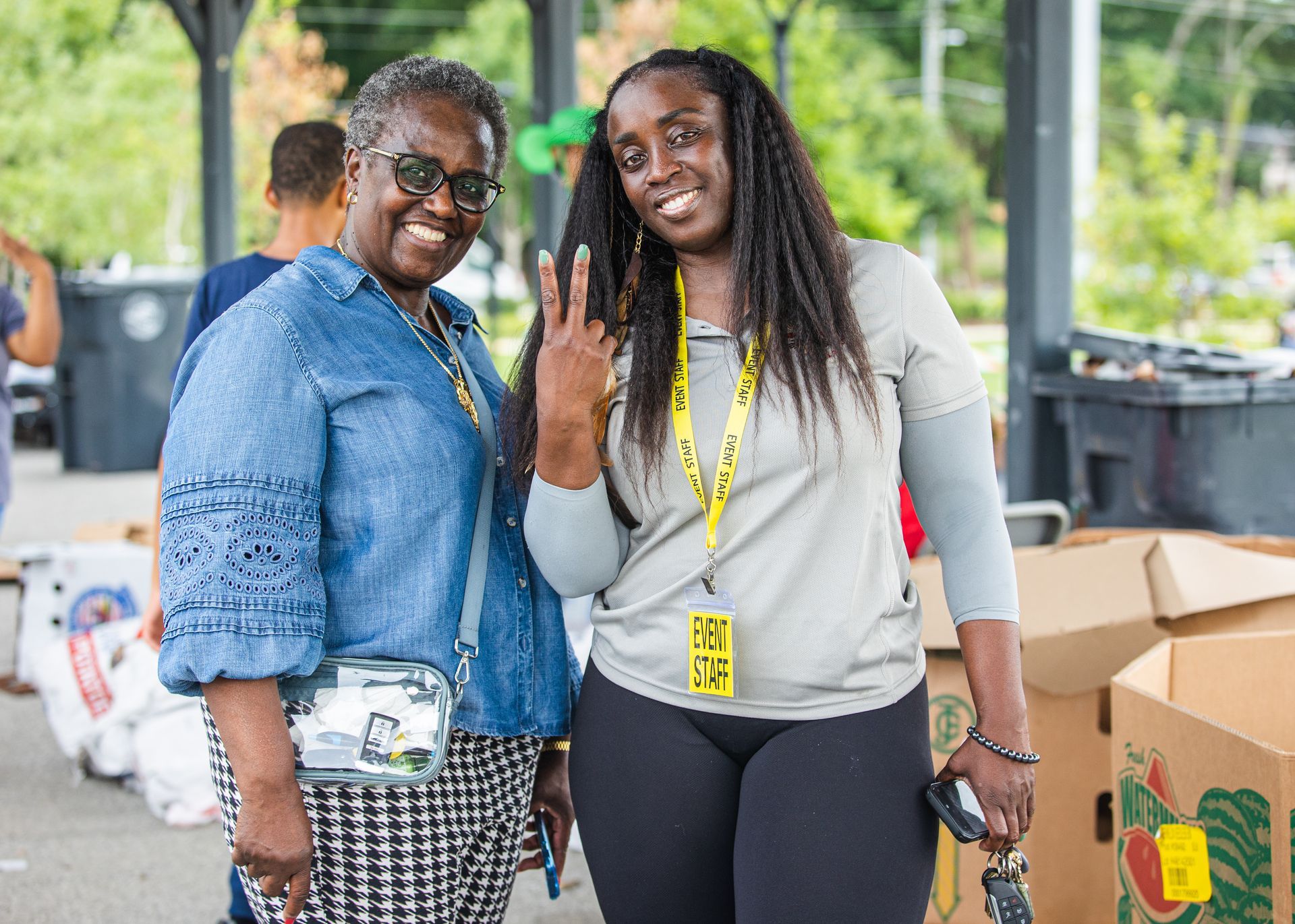 Two women are standing next to each other and smiling for the camera.