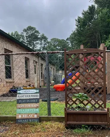 A fence with a sign on it that says `` plant your roots ''