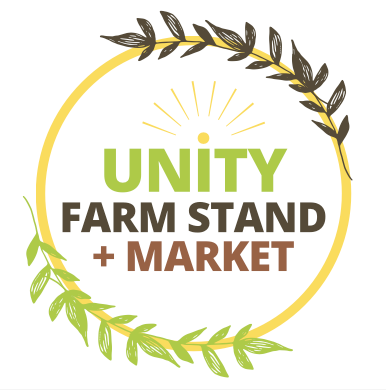 A woman wearing a mask is standing in front of a little lion farmstand.