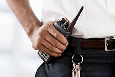 Security Personnel Holding a Telephone Radio - Security on Indianapolis, IN