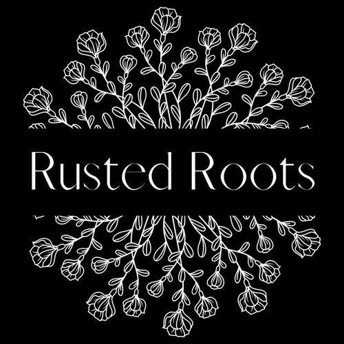 A logo for rusted roots with white flowers on a black background.