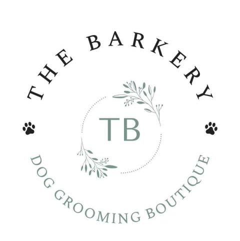 A logo for a dog grooming boutique called the barkery dog grooming boutique.