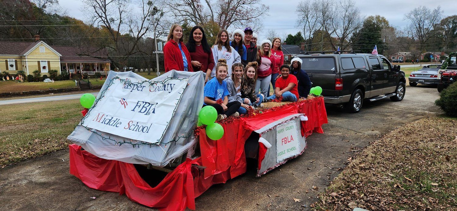 A group of people are riding on a float in a parade.