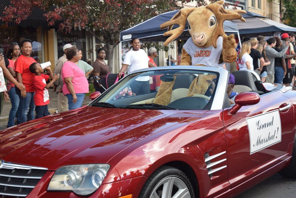 A red car with a sign that says ' ford ' on it