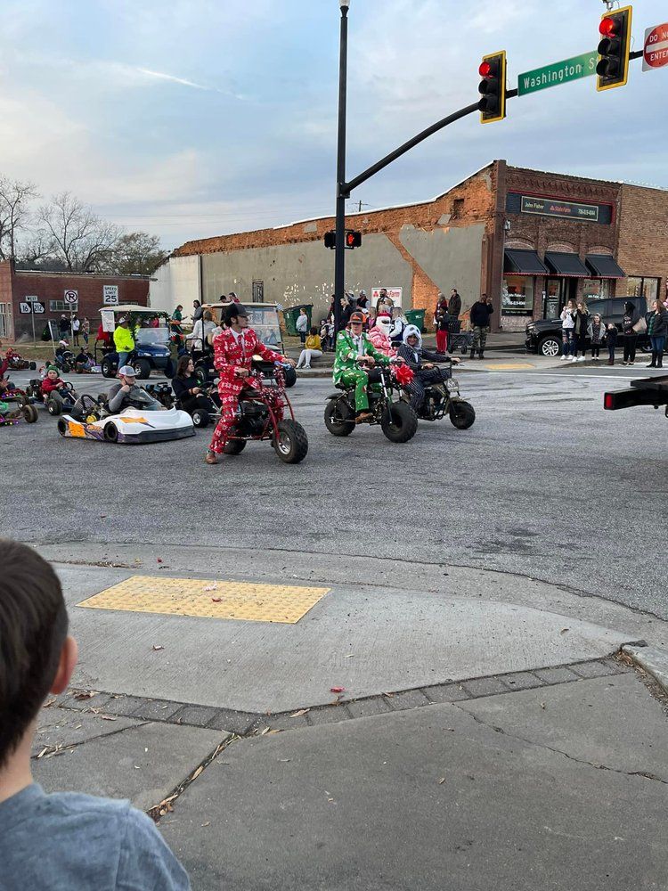 A group of people are riding motorcycles down a street.