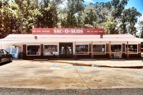 A car is parked in front of a sac-o-suds store