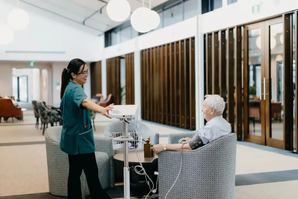 Nurse checking resident’s blood pressure