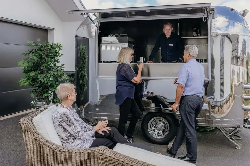 Residents chatting at outdoor café trailer