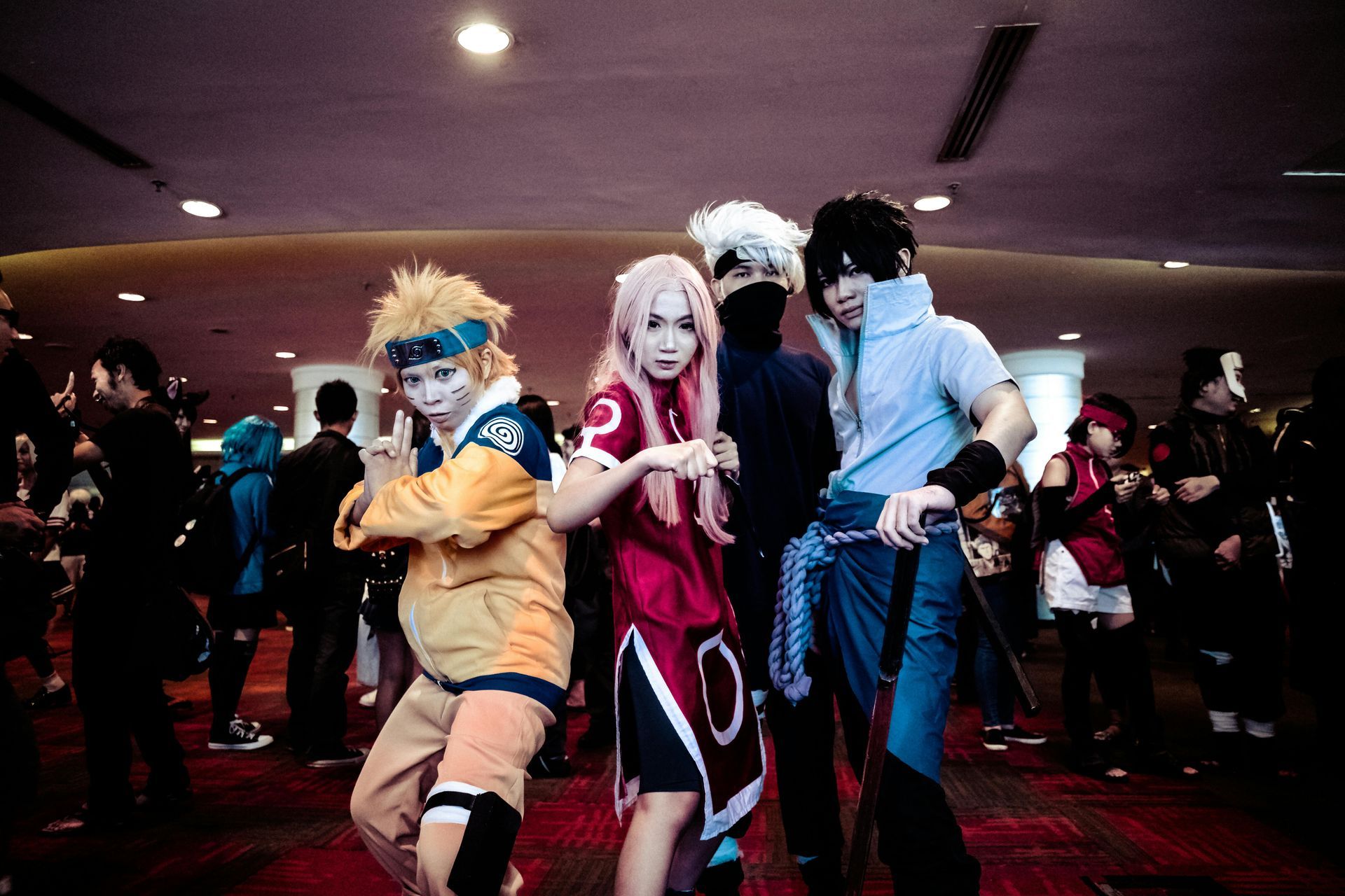 A group of people dressed in anime costumes are posing for a picture.