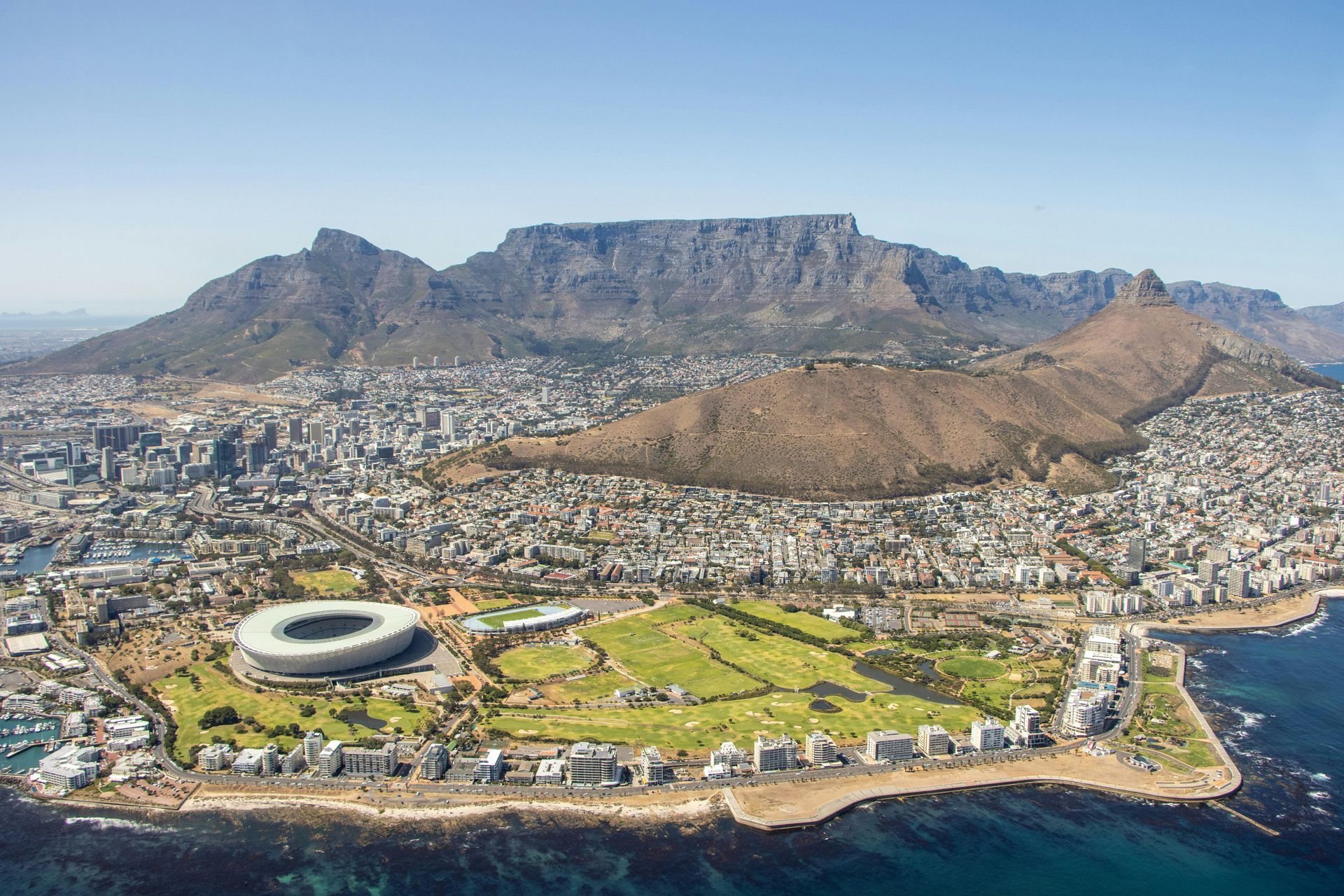An aerial view of a city with a mountain in the background