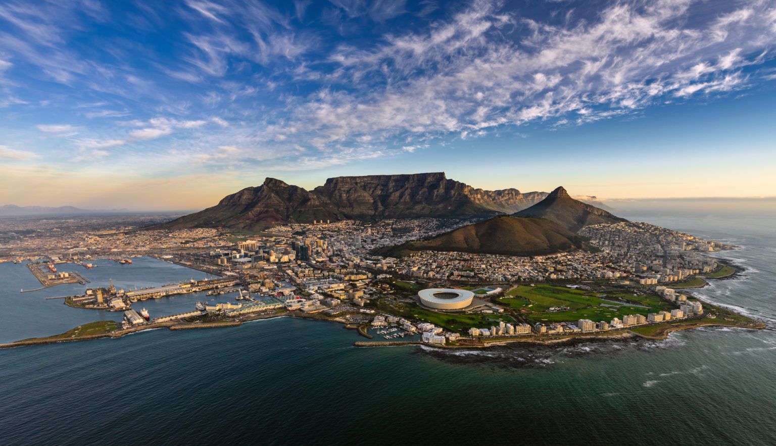 An aerial view of cape town with a mountain in the background.