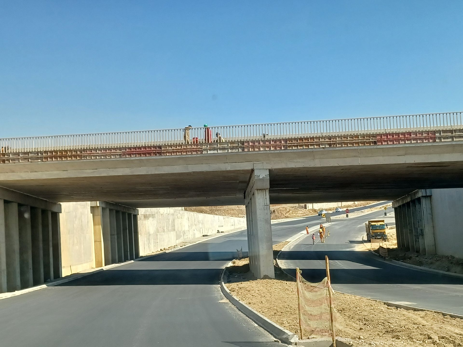 A bridge over a road that is under construction