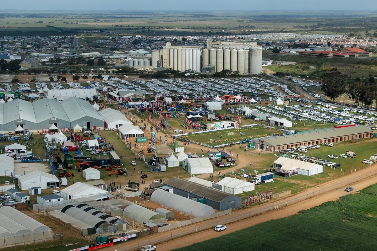 An aerial view of a large field with lots of tents and buildings