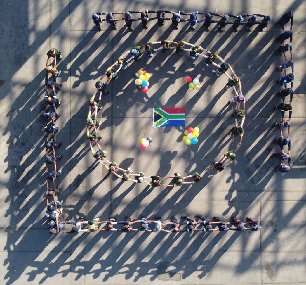 NJR Steel staff creating their logo with the staff members in a row
