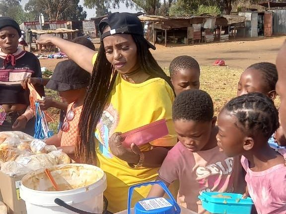 Alinah Ntswaki, often referred to as the Angel from Henley, feeding children in the community