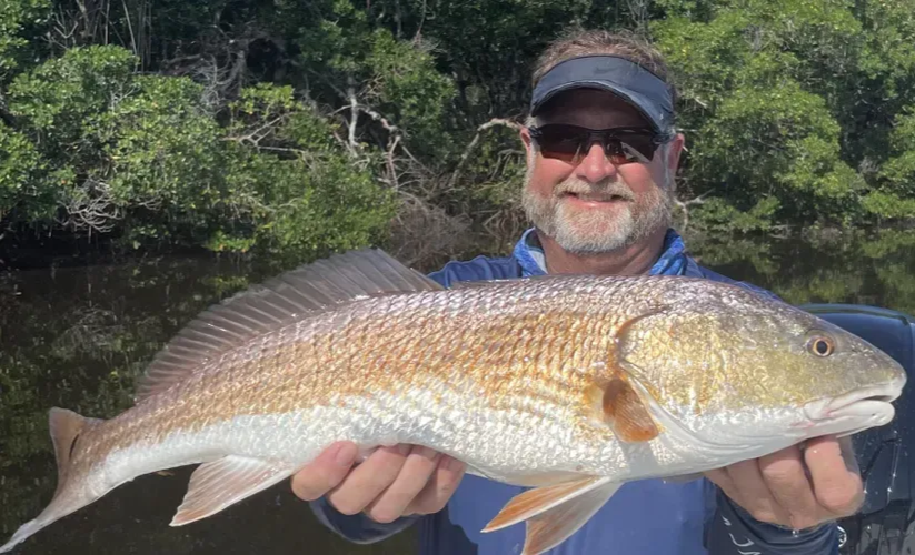 Captain Carl holding a redfish