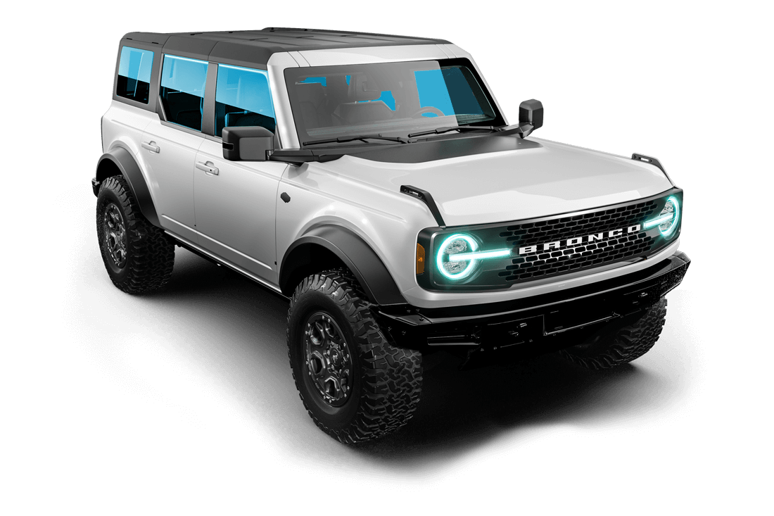 A white ford bronco with pink lights on the front is on a gray background.