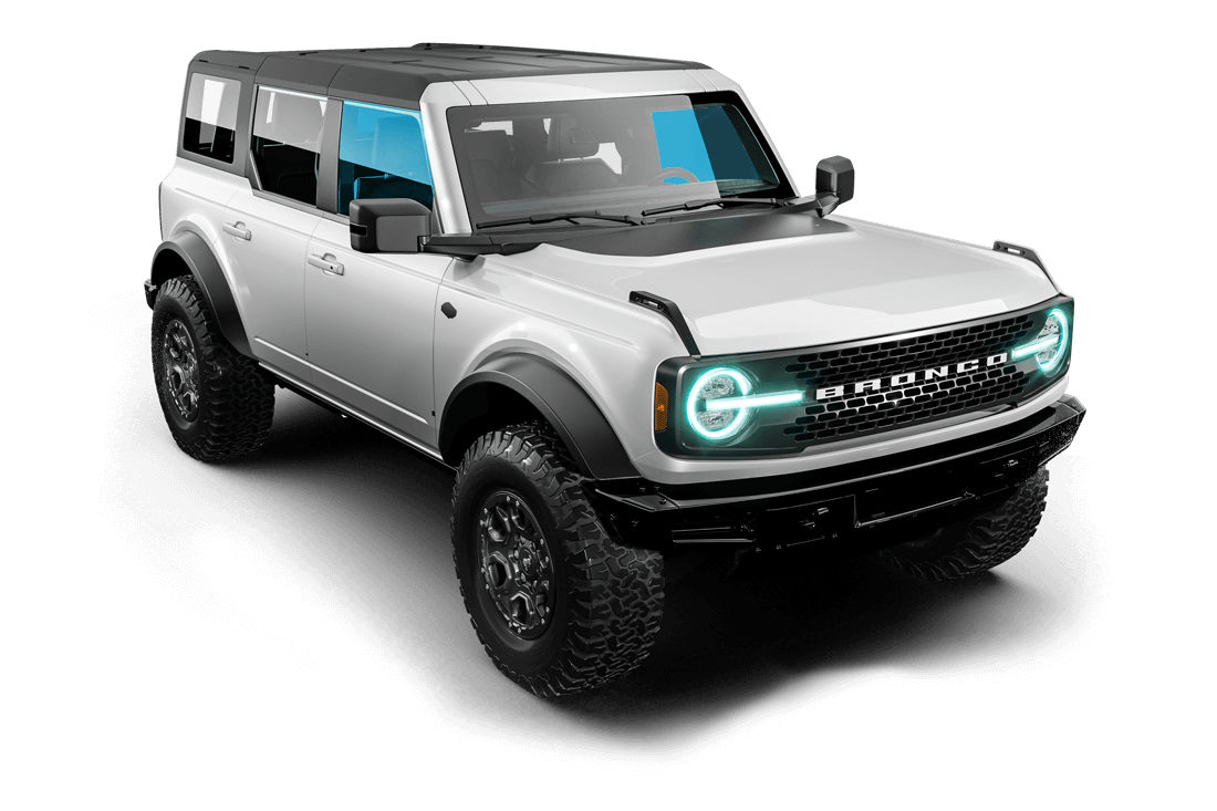 A white ford bronco is sitting on a gray surface.