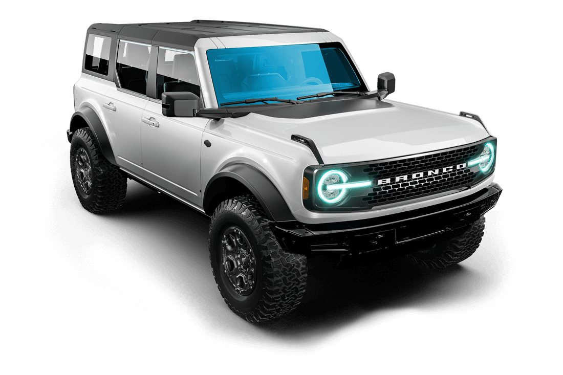 A white ford bronco is sitting on a gray surface.