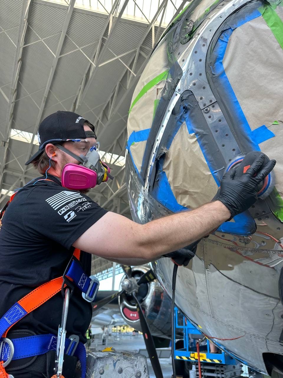 Britt Stokes polishing the nose of a B-29 bomber at the Museum of Flight in Seattle, WA as a member of the 2025 Air Force One Detailing Team.