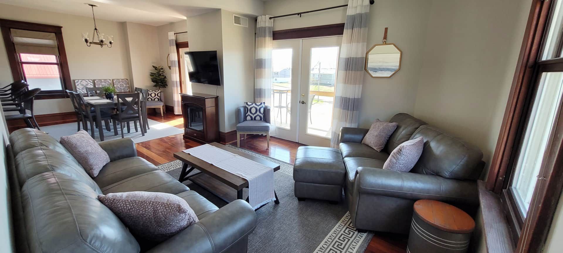 A living room with a couch , chairs and a table.